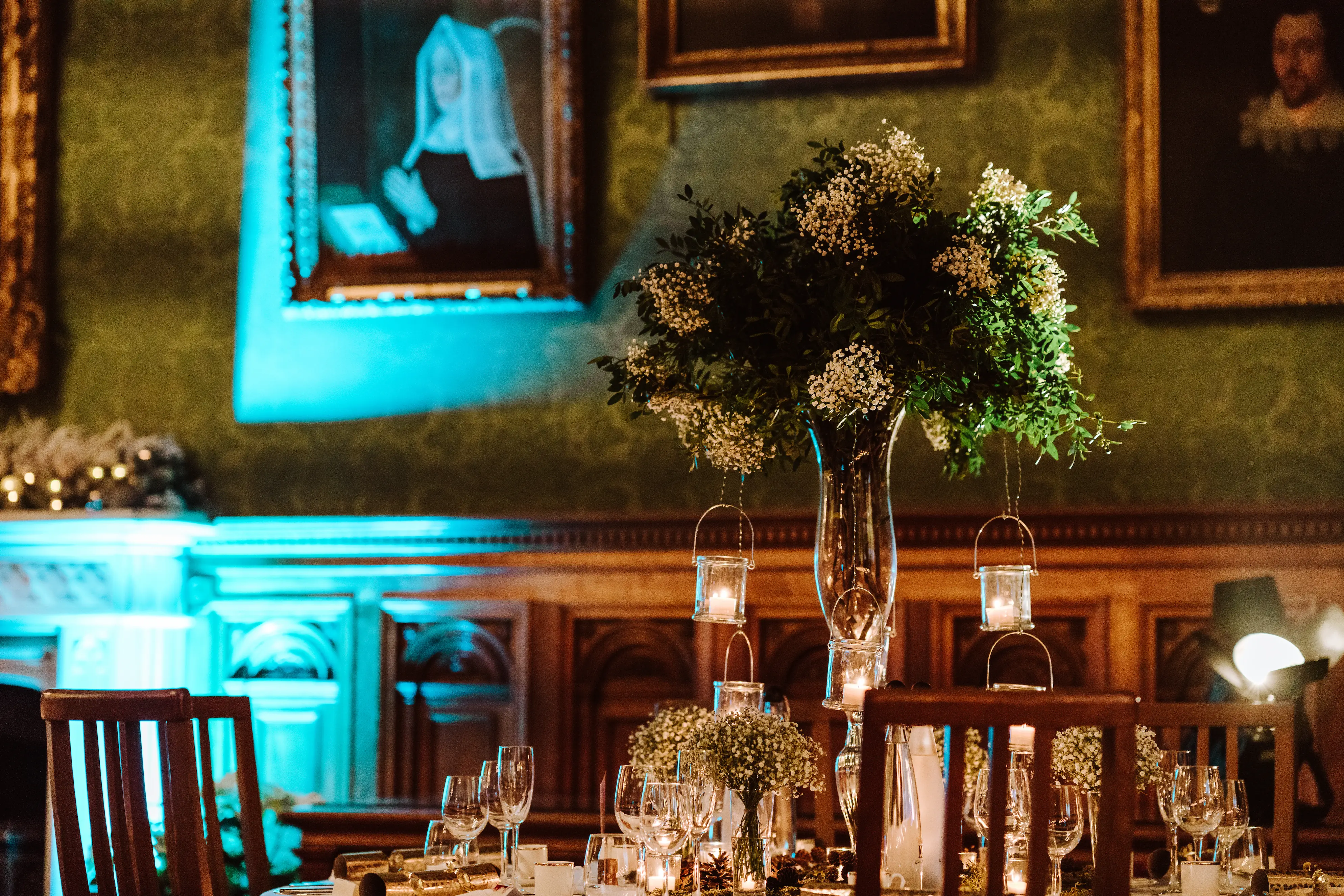 Chair flower bunches moved into bud vases and clustered underneath a tall wedding table arrangement